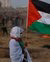 Woman holding Palestinian flag at Israel-Gaza border