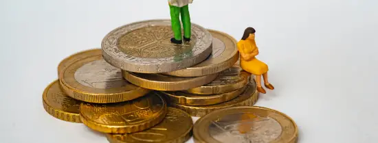 Two small human figures sitting and standing on a pile of Euros