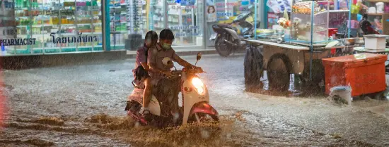 Motorcyclists in rain floods